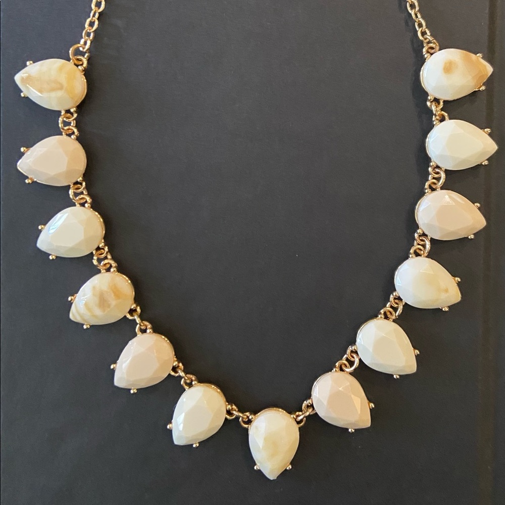 White, light brown, and gold necklace.